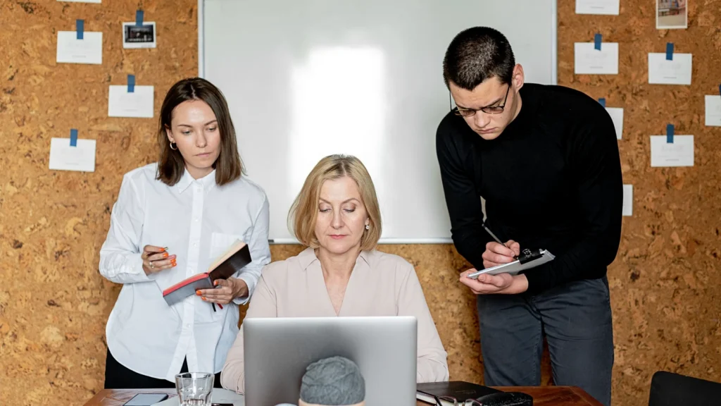 business owner comparing technology options on laptop and phone side by side