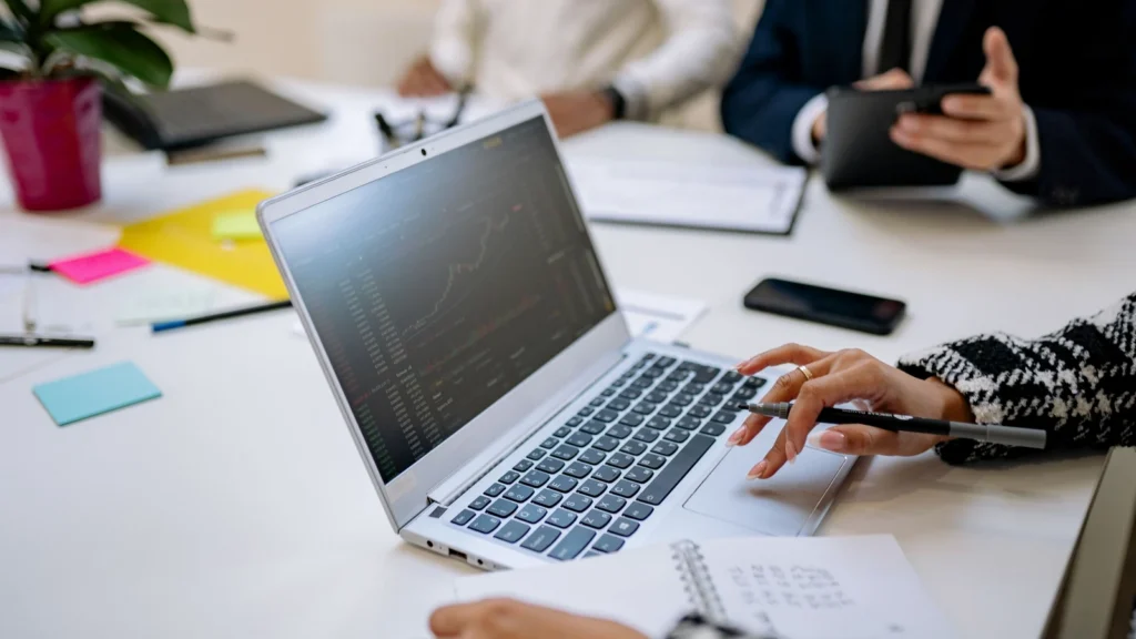colleagues reviewing a business report together on a laptop