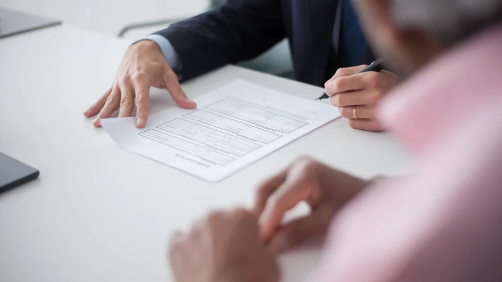 two colleagues reviewing and signing a website maintenance agreement